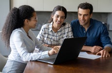 Couple talking to a financial advisor about an investment