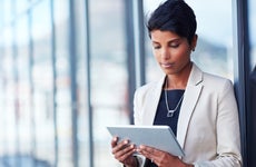 Shot of a young businesswoman using a digital tablet outside of an office