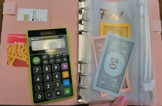 Pocketbook, calculator, and monopoly game money