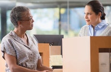 Woman at bank talking to teller