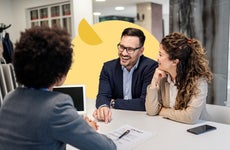 Financial manager meeting with couple in bank branch office