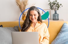 Woman accessing her checking account at home on a laptop