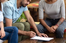 Borrowers meet with a loan officer to refinance their mortgage.