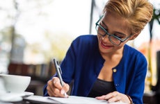 Women happily signing a financial document