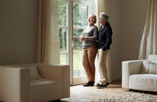 Older couple looking out of the window