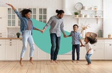 A happy family jumping in a kitchen