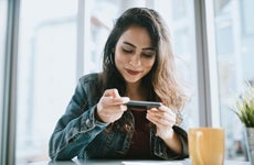 Young Woman Depositing Check With Smartphone