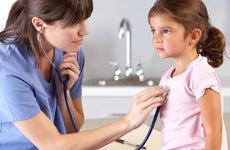 A young girl visits a doctor.