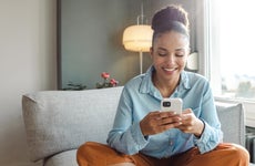 Young woman using a smart phone at home