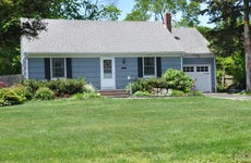 A one-story single-family home and yard