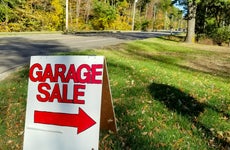 Garage sale in grass on street curb with autumn trees background