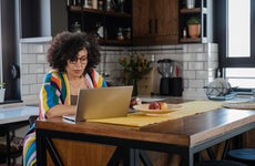 woman using laptop in the kitchen