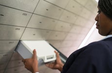 Woman taking safety deposit box out